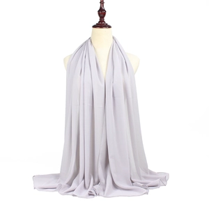 Detail of light grey chiffon hijab with soft drape and smooth texture on a display mannequin