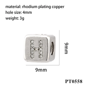 Macro detail of 9mm silver square bead with H initial and zirconia inlay specifications