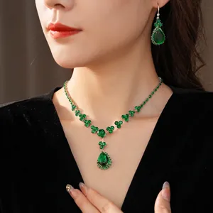 Exquisite silver-tone emerald drop jewelry set with necklace and earrings on model