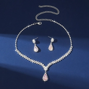 Detailed macro shot of silver teardrop necklace and earring set with shimmering AB crystals