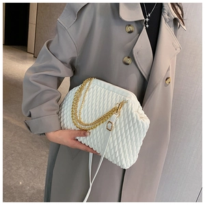 Detail of white pleated cloud bag with quilted stitching and gold chain strap