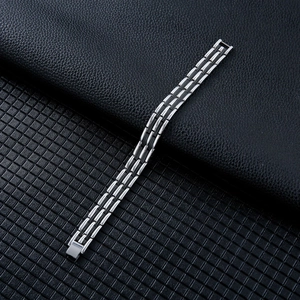 Close-up of a silver wheat-link titanium steel bracelet with fold-over clasp detail
