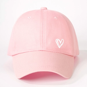 Close-up of white heart embroidery on pink cotton twill baseball cap fabric