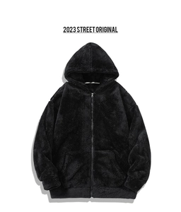 Detail of black fleece hoodie texture featuring metal zipper and ribbed cuffs for men