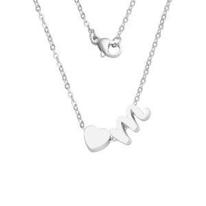 Detail of silver heart and cursive letter M pendant on a delicate cross chain