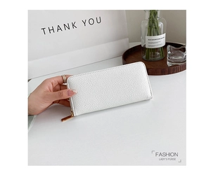 Detail showing white lychee texture leather purse with golden zipper and hand holding
