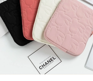 Detailed close-up of quilted rabbit pattern on colorful laptop sleeves with soft fabric texture