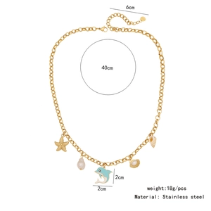 Detail of golden stainless steel necklace with starfish, dolphin, and shell charms