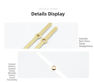 Detail of gold metal clock hands showing smooth finish and brass sleeve structure