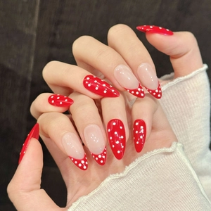 Red and white polka dot long stiletto press-on nails with French tip design for women