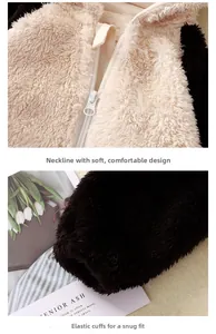 Detail of baby plush jumpsuit with white zipper and black elastic cuffs on soft fleece