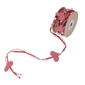 Detailed view of red heart print ribbon with faux pearls and jute twine for gift wrapping
