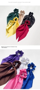 Close-up of silk satin scrunchies with long streamers in multiple vibrant colors