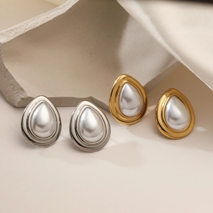 Elegant 18K gold and silver waterdrop pearl stud earrings set on a silk backdrop