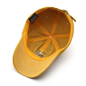 Inside view of a yellow washed cotton baseball cap showing reinforced seams and eyelets