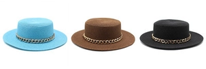 Flat top straw boater hats in blue, brown, and black with decorative thick gold chains