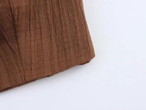 Detailed macro view of the brown ribbed fabric texture and embossed vertical patterns