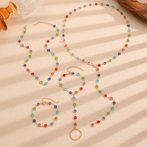 Detail of bohemian gold alloy jewelry set with colorful rhinestones under shadow light