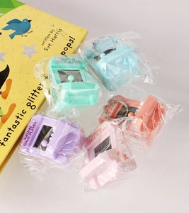 Close-up of colorful mini arcade game keychains in pastel green blue purple and pink