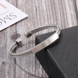 Detail of silver twisted cable cuff bracelet with brushed steel plate on jewelry box