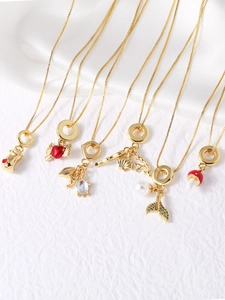 Detail of assorted gold-plated necklaces with heart, shell, and fishtail pendants