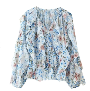 Detailed view of V-neck floral chiffon shirt with ruffle trim and buttoned front