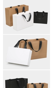 Three premium paper gift bags in brown, white, and black with wide black ribbon handles