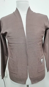 Detailed view of brown knit cardigan featuring front patch pockets and fashion label detail