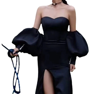 Elegant black off-shoulder maxi dress featuring dramatic puff sleeves and pearl buttons