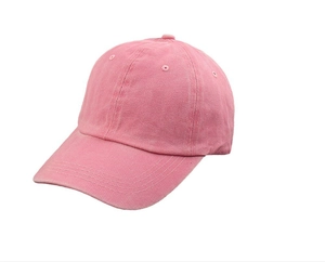 Close-up of pink washed cotton baseball cap texture with vintage distressed finish