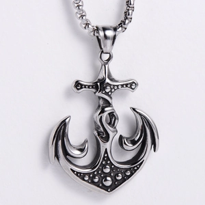 Detailed macro view of silver nautical anchor pendant with textured industrial finish