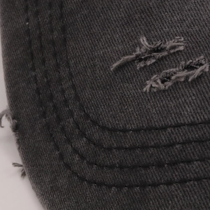 Close-up of distressed baseball cap brim with triple stitching and frayed edges
