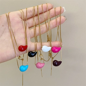 Handheld display of colorful teardrop pendants on gold-tone box chains with lobster clasps