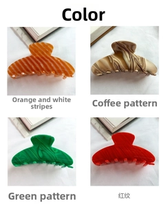 Detail view of four large cellulose acetate hair claws in various marble textures