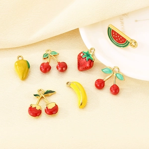 Detailed macro view of vibrant colorful fruit-shaped drip oil charms on a white plate