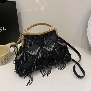 Fashionable black evening bag with sequins, gold handle, and tassel detail