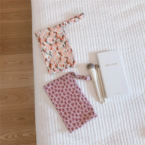 Close-up of floral seersucker fabric texture on mini cotton pouches for organizers