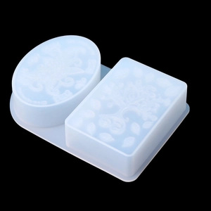 Detailed macro view of dual-cavity silicone mold with intricate floral embossed patterns