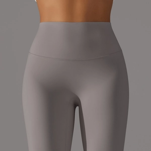 Close-up of high-waisted yoga pants with reinforced seams and elastic slimming waistband