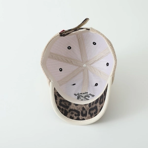Detailed internal view of knit baseball cap with leopard print brim and embroidery
