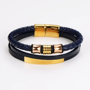 Detail of navy blue leather braided bracelet featuring gold and rose gold magnetic clasp