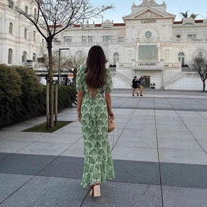 Detail of the backless tie design and green fan print on a puff sleeve maxi dress