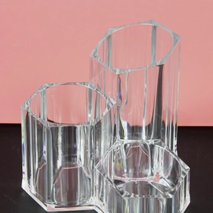 Clear acrylic hexagonal makeup brush holder with three compartments for vanity desk storage