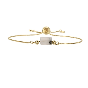 Detailed macro of gold box chain bracelet with natural white marble stone bar