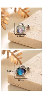 Macro shot of snake-shaped earring with moonstone showing dimensions 0.85cm by 0.82cm