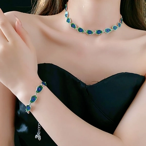 Detail of silver necklace and bracelet with blue and green lotus leaf enamel design