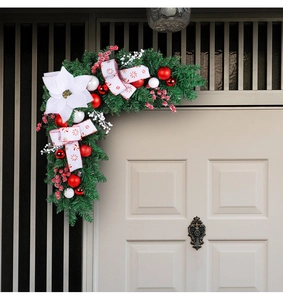 L-shaped Christmas door frame wreath with white poinsettia, red baubles and pine branches