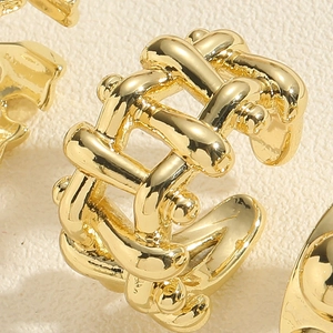 Macro shot of gold woven texture ring with polished finish and open adjustable design