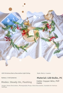 Close-up of LED Christmas garland with red berries, pine needles and pinecones on white cloth