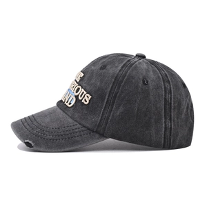 Close-up of distressed brim and 3D embroidery on washed cotton baseball cap
